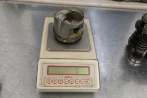 Weigh out pistons and adjust weight 2-cylinder engine